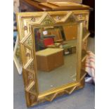 A VICTORIAN GOTHIC REVIVAL GILT AND POLYCHROME DECORATED WALL MIRROR. 68 x 89cms.