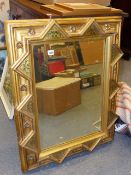 A VICTORIAN GOTHIC REVIVAL GILT AND POLYCHROME DECORATED WALL MIRROR. 68 x 89cms.