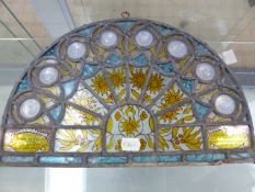 A ROUND ARCHED LEADED GLASS PANEL, THE EIGHT FAN SHAPED PANELS ABOVE OCHRE BERRIED LEAVES AND TWO
