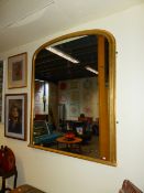 A LATE VICTORIAN GILDED DOMED OVERMANTLE MIRROR 147CM H X 117CM W.