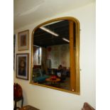 A LATE VICTORIAN GILDED DOMED OVERMANTLE MIRROR 147CM H X 117CM W.