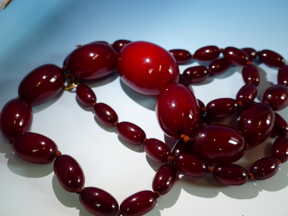 A GRADUATED ROW OF CHERRY AMBER BEADS, KNOTTED. LENGTH 76cms, WEIGHT 60 grams. - Image 6 of 21