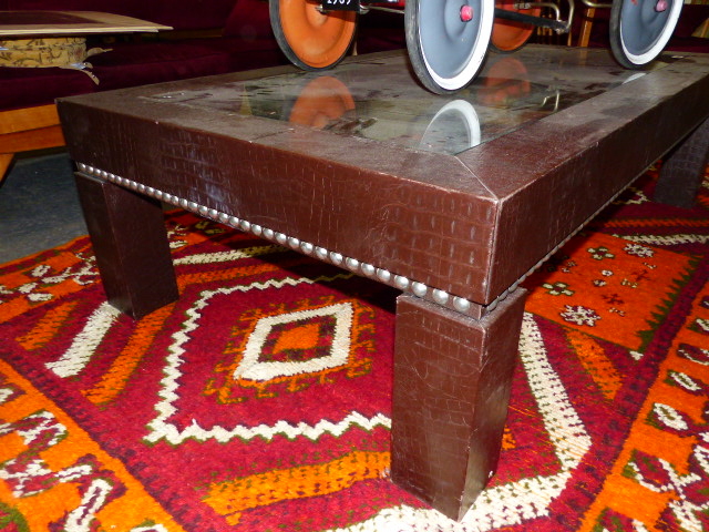 A CONTEMPORARY DESIGNER LOW TABLE WITH GLAZED TOP AND FAUX ALLIGATOR NAILED COVERING. W.1140 x H. - Image 2 of 4