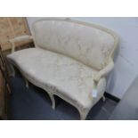 A CARVED AND PAINTED LOUIS XV STYLE SALON SETTEE WITH SHAPED UPHOLSTERED BACK AND SEAT ON CABRIOLE