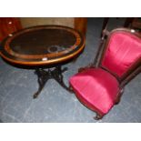 AN EBONY OVAL TABLE WITH FOLIAGE MARQUETRIED YEW WOOD BAND, THE FOUR SUPPORTING COLUMNS ON SPLAY