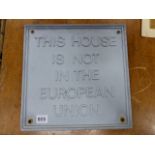 A VINTAGE 1970'S ALLOY WALL PLAQUE, THIS HOUSE IS NOT IN THE EUROPEAN UNION. 30 x 30cms.