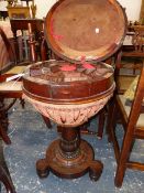 A ROSEWOOD WORK TABLE, THE HINGED CYLINDRICAL LID OVER AN OCTAGON OF OF COMPARTMENTS SWIVELLING OVER