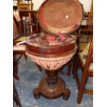 A ROSEWOOD WORK TABLE, THE HINGED CYLINDRICAL LID OVER AN OCTAGON OF OF COMPARTMENTS SWIVELLING OVER