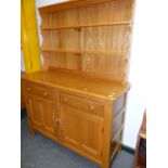 AN ERCOL PALE ELM DRESSER WITH OPEN PLATE RACK. 123 x 48cms.