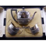 A CAMPBELL & LUMBY CASED SILVER THREE PIECE TEASET, THE HALF GADROONED TEA POT AND CREAM JUG,