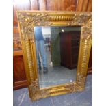 A GILT FRENCH STYLE WALL MIRROR WITH BEVELLED PLATE. H.124 x W.92cms. (corrcted description