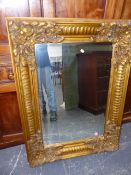 A GILT FRENCH STYLE WALL MIRROR WITH BEVELLED PLATE. H.124 x W.92cms. (corrcted description