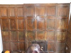 A QUANTITY OF OAK LINEN FOLD CARVED WALL PANELLING.