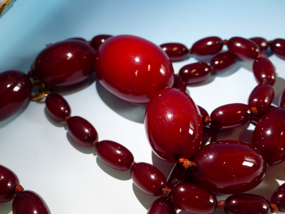 A GRADUATED ROW OF CHERRY AMBER BEADS, KNOTTED. LENGTH 76cms, WEIGHT 60 grams. - Image 7 of 21