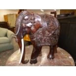 A WELL CARVED SOLID ROSEWOOD OR COROMANDEL FIGURE OF A STANDING ELEPHANT. H.50cms