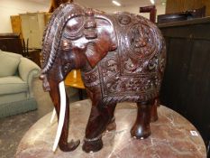 A WELL CARVED SOLID ROSEWOOD OR COROMANDEL FIGURE OF A STANDING ELEPHANT. H.50cms