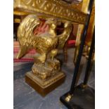 A MOTTLED RED MARBLE TOPPED CONSOLE TABLE SUPPORTED BY A GILT SPREAD EAGLE ON RECTANGULAR PLINTH.