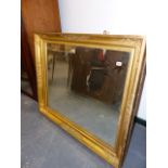 AN ANTIQUE WALL MIRROR WITHIN FINELY DECORATED VICTORIAN GILT FRAME. 115 x 97cms.