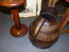 AN OAK BREAD OVEN PADDLE, AN IRON COOPERED OAK JUG. H.38cms AND A TREEN SPOOL. W.41cms. (3)
