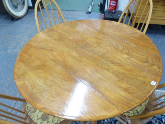 AN ERCOL PALE ELM DROP LEAF DINING TABLE AND A SET OF FOUR HIGH HOOP BACK DINING CHAIRS. (5) - Image 4 of 7