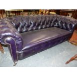 A LATE VICTORIAN LEATHER BUTTON UPHOLSTERED CHESTERFIELD SETTEE ON TURNED FORELEGS. W.199cms.