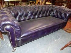 A LATE VICTORIAN LEATHER BUTTON UPHOLSTERED CHESTERFIELD SETTEE ON TURNED FORELEGS. W.199cms.