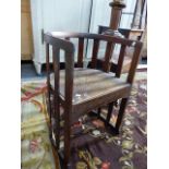 AN ARTS AND CRAFTS MAHOGANY CHAIR, IN THE MANNER OF LIBERTYS .THE HALF ROUND TOP RAIL AND FOOT