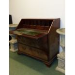 AN UNUSUAL GEORGIAN SLANT TOP BUREAU OF GENEROUS PROPORTIONS WITH FITTED INTERIOR OVER THREE ALIGNED