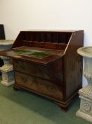 AN UNUSUAL GEORGIAN SLANT TOP BUREAU OF GENEROUS PROPORTIONS WITH FITTED INTERIOR OVER THREE ALIGNED