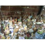 A LARGE QUANTITY OF BESWICK BEATRIX POTTER FIGURES WITH A STAND AND A PAIR OF GERMAN PORCELAIN ETC