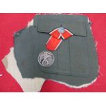 THIRD REICH 1923-1933 BLOOD ORDER MEDAL, NUMBER 2565 MOUNTED ON RIBBON AND FIXED TO A UNIFORM