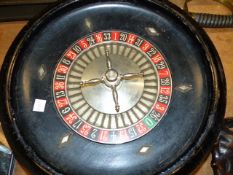 A VINTAGE ROULETTE WHEEL AND TABLE COVER TOGETHER WITH VARIOUS BONE AND OTHER COUNTERS. (QTY)