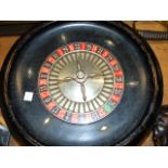 A VINTAGE ROULETTE WHEEL AND TABLE COVER TOGETHER WITH VARIOUS BONE AND OTHER COUNTERS. (QTY)