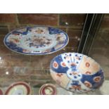 TWO CHINESE EXPORT IMARI PLATES, THE LARGER WITH PRECIOUS OBJECTS AND FLOWERS. Dia.25cms, THE