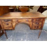 A REGENCY MAHOGANY WRITING TABLE, THE RECTANGULAR TOP OVER A CONFIGURATION OF SEVEN DRAWERS,