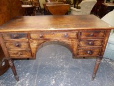 A REGENCY MAHOGANY WRITING TABLE, THE RECTANGULAR TOP OVER A CONFIGURATION OF SEVEN DRAWERS,