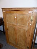 A 19tH.C.PINE CORNER CABINET WITH SINGLE FOUR PANEL DOOR. W.104 x H.108cms.