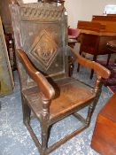 AN 18th.C.AND LATER OAK WAINSCOT CHAIR WITH CARVED CREST RAIL.