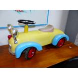 A VINTAGE STYLE TIN PLATE CHILD'S RIDE-ON TOY CAR WITH EYE HEADLAMPS. L.74cms.