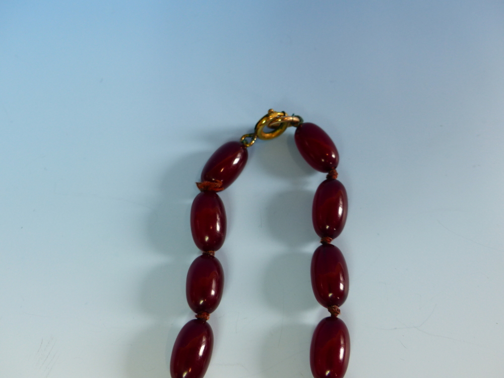 A GRADUATED ROW OF CHERRY AMBER BEADS, KNOTTED. LENGTH 76cms, WEIGHT 60 grams. - Image 14 of 21