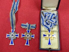 THIRD REICH MOTHER'S CROSS IN GOLD AND FURTHER EXAMPLES IN SILVER AND BRONZE, THE GOLD EXAMPLE,