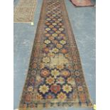 AN ANTIQUE CAUCASIAN SHIRIVAN RUNNER. 430 x 102cms.