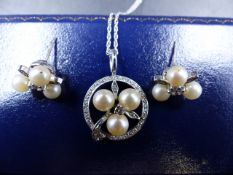 AN 18ct WHITE GOLD DIAMOND AND PEARL PENDANT AND EARRING SET. THE BRILLIANT CUT CENTRE DIAMOND