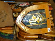 A LARGE QUANTITY OF REGIMENTAL AND OTHER BADGES MOUNTED ON WOODEN SHIELDS TOGETHER WITH THREE