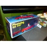 A CHINESE TINPLATE BATTERY OPERATED " PHOTOING ON CAR" TOY IN ORIGINAL BOX.