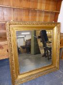 A VICTORIAN GILT FRAMED WALL MIRROR. 105 x 106cms.