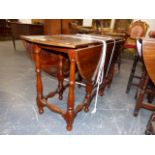 A SOLID YEW WOOD COTTAGE GATELEG SUPPER TABLE ON TURNED LEGS AND STRETCHERS. W.118 x H.69cms.