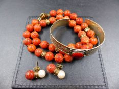 A UNIFORM ROW OF CORAL KNOTTED BEADS INTERSPERSED WITH GOLD RONDELLES AND FINISHED WITH A 9ct GOLD