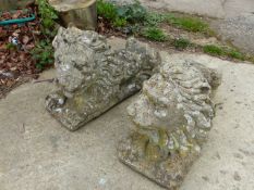 A PAIR OF WEATHERED COMPOSITE STONE LION FIGURES.