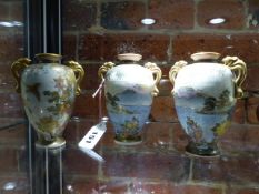 HOTODA. THREE SATSUMA VASES, EACH OF THE OVOID BODIES PAINTED WITH FLOWERS AND WITH PAIRS OF GILT